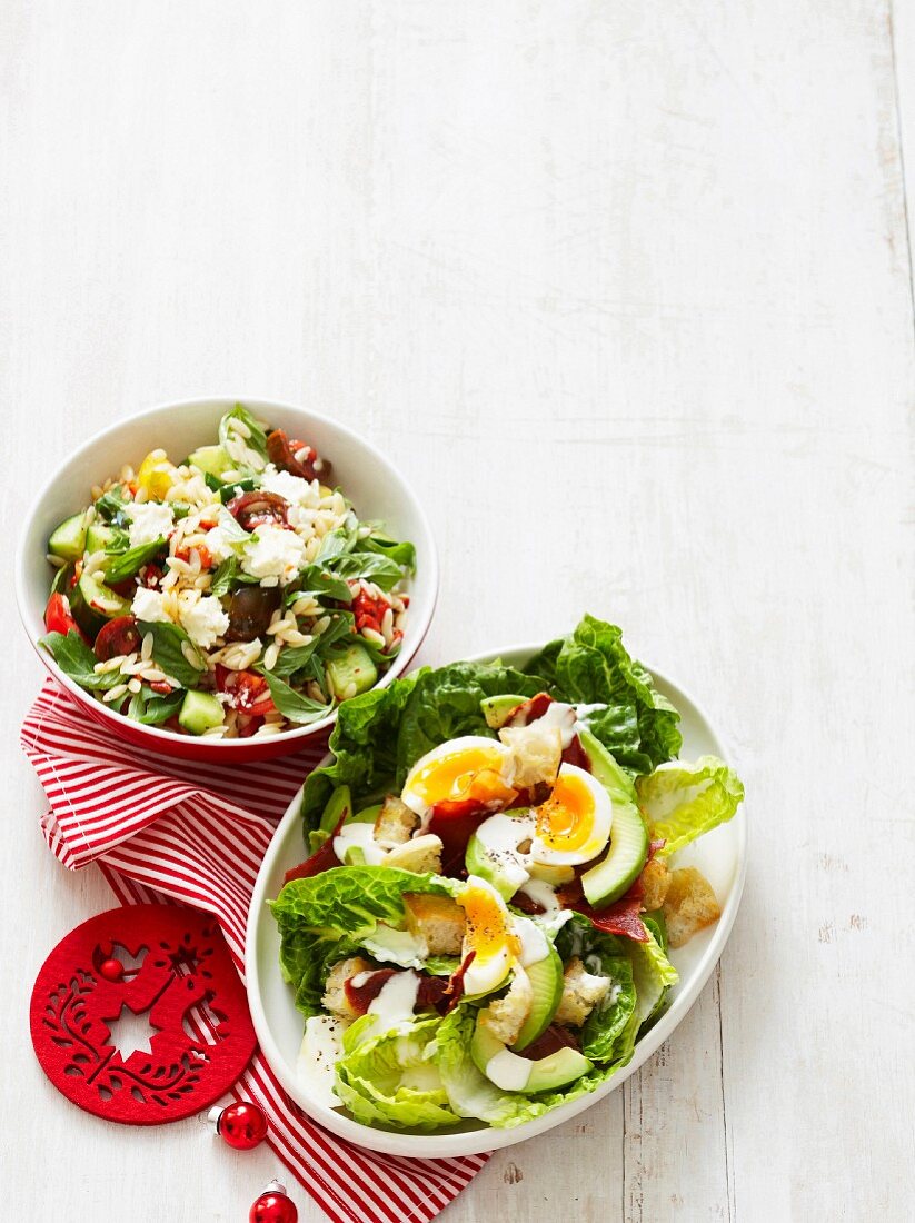 Caesar salad with avocado and an orzo salad with rocket