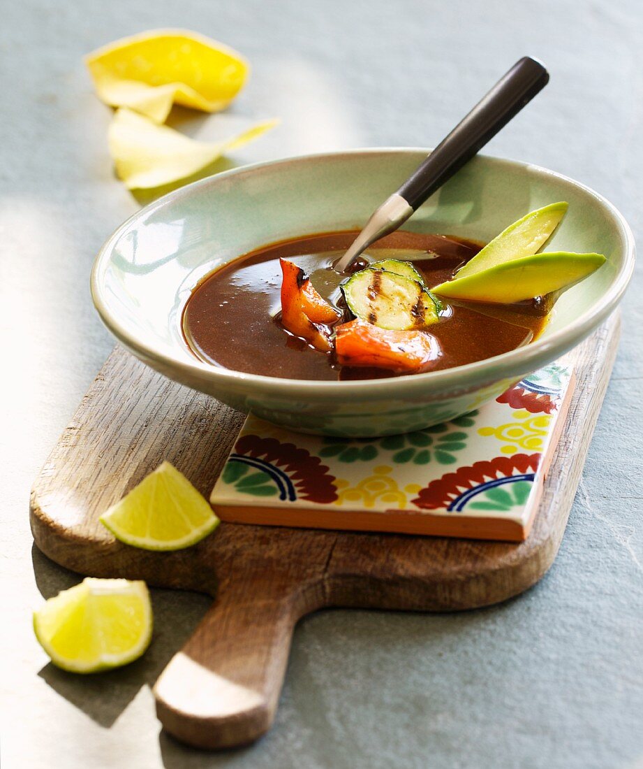Mexican soup with avocado, tomato and courgette