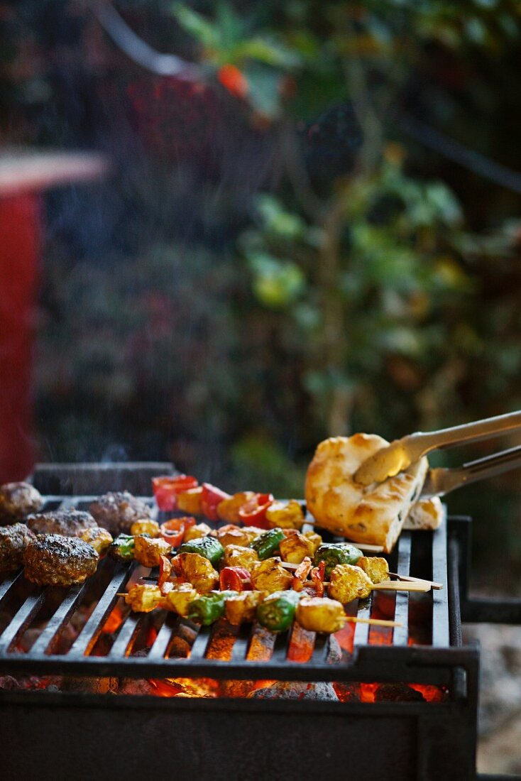 Kebabs, flatbread and meatballs on the barbecue