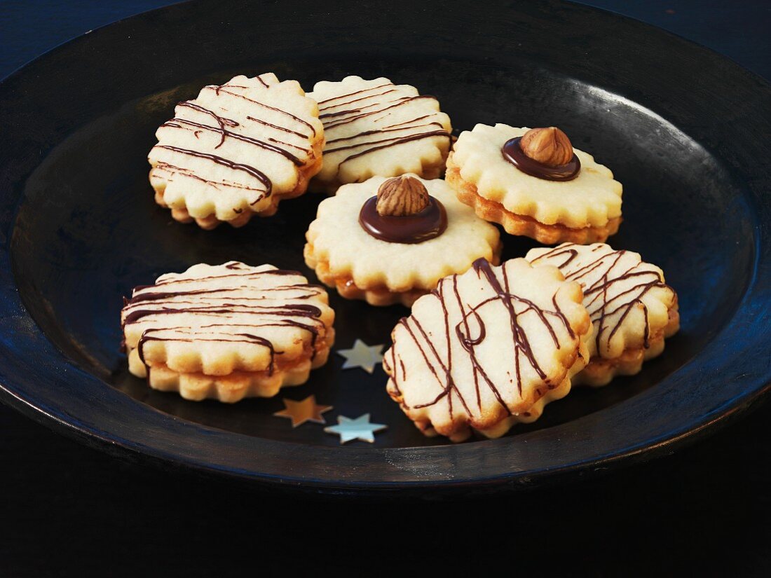 Christmas biscuits with chocolate stripes and hazelnuts