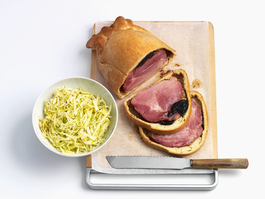 Rolled ham wrapped in pastry with a cabbage salad