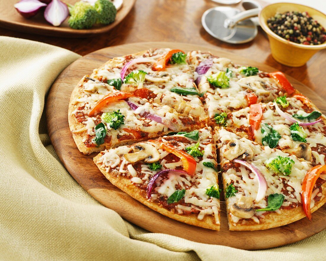 Vegetable pizza with red onions, peppers, broccoli, basil and mushrooms