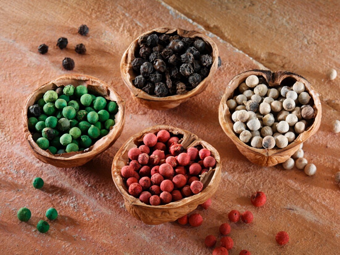 Colourful peppercorns in walnut shells