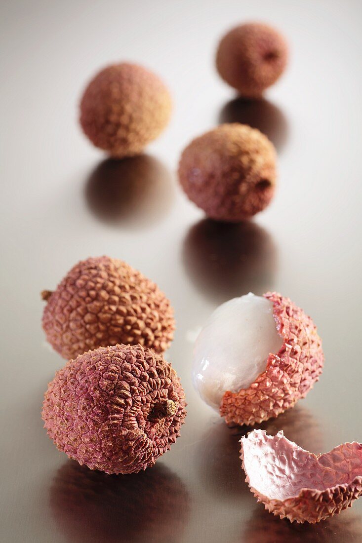 A few lychees, whole and cut open