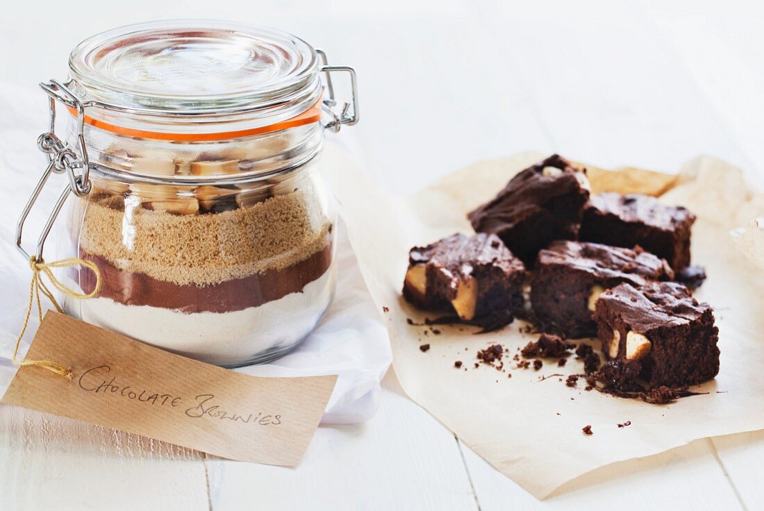 A preserving jar containing the dry ingredients for making brownies, and several brownies