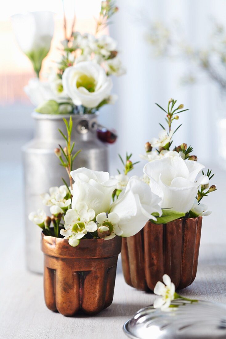 Jelly moulds & small milk can used as vases for waxflowers & lisianthus