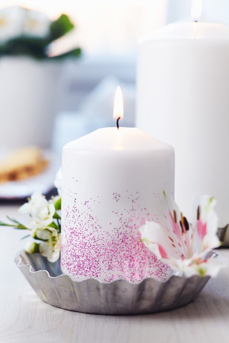Tart tin used as candle holder decorated with waxflowers & lilies