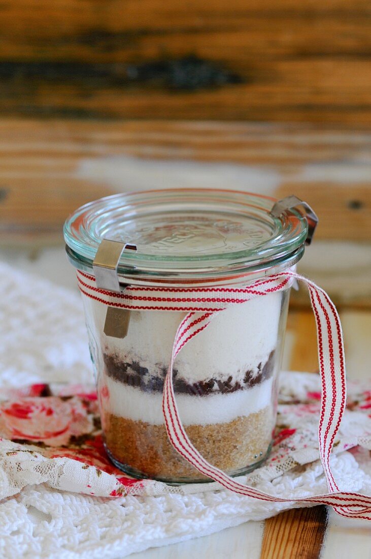A preserving jar containing the dry ingredients for chocolate biscuits