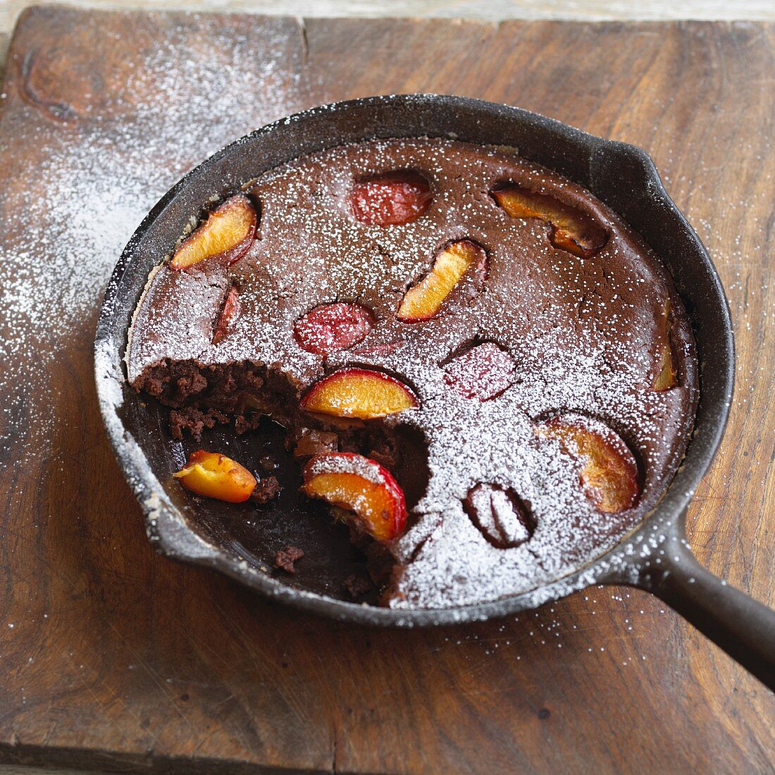Chocolate and peach clafoutis dusted with icing sugar