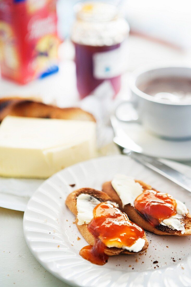 Slices of toast with butter and jam, with a cup of coffee