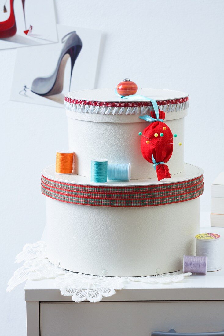 Hat boxes decorated with ribbons and furniture knobs