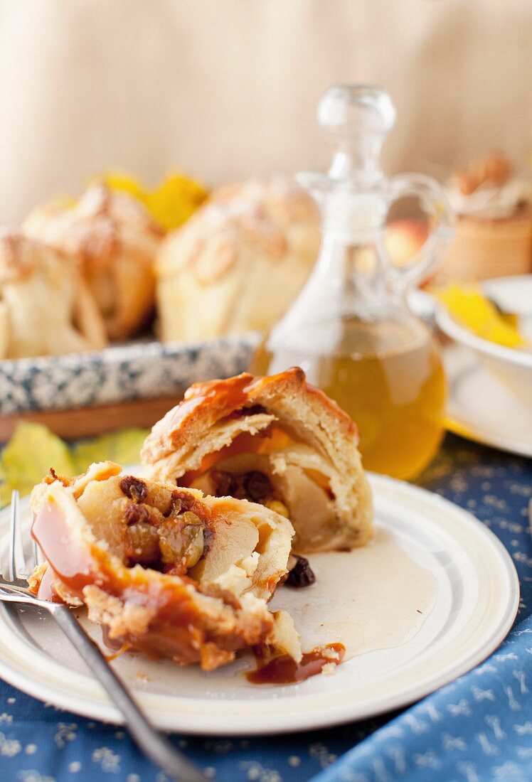 An apple dumpling stuffed with dried fruit and topped with caramel sauce