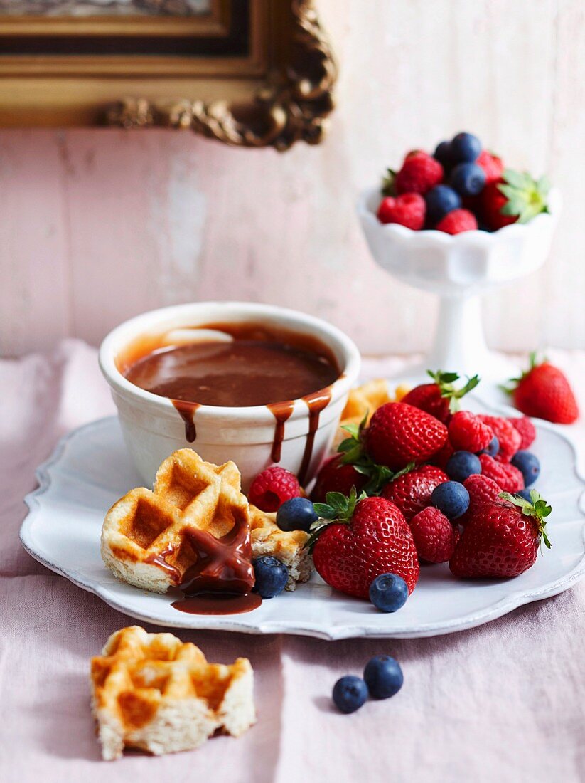 Chocolate fondue with waffles and berries