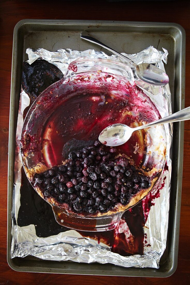 Half Eaten Blueberry Pie with Two Spoons; From Above