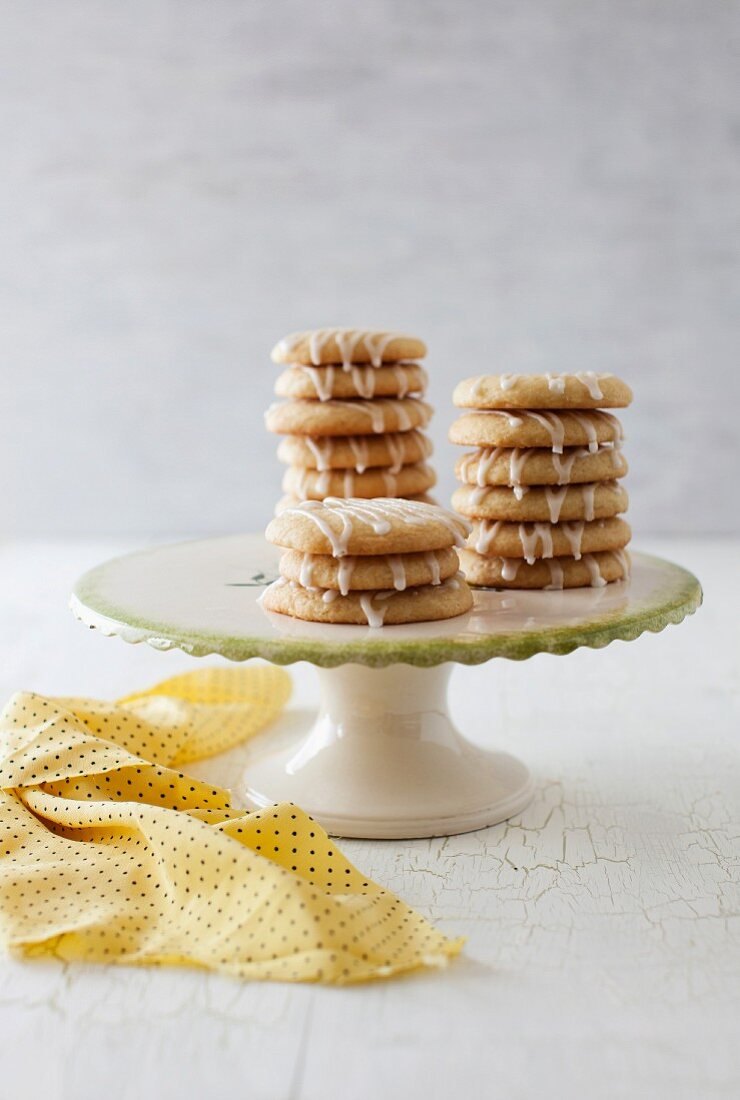 Glazed lemon biscuits on a cake stand