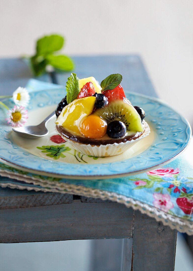 A fruit tartlet with mint leaves