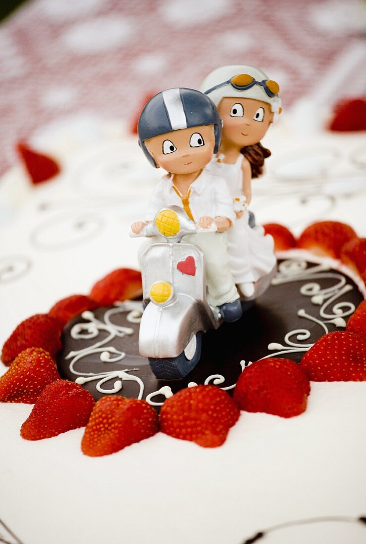 A decorative bridal couple on a wedding cake