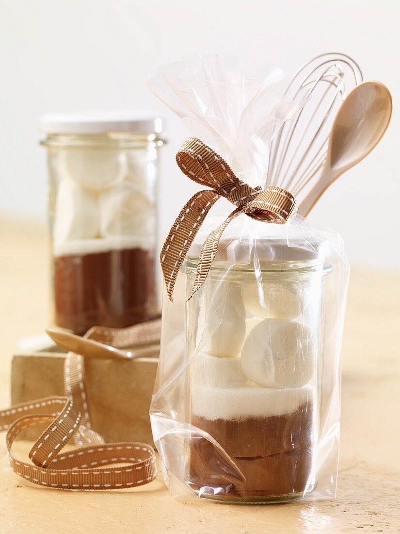 A jar containing the dry ingredients for making hot chocolate with marshmallows