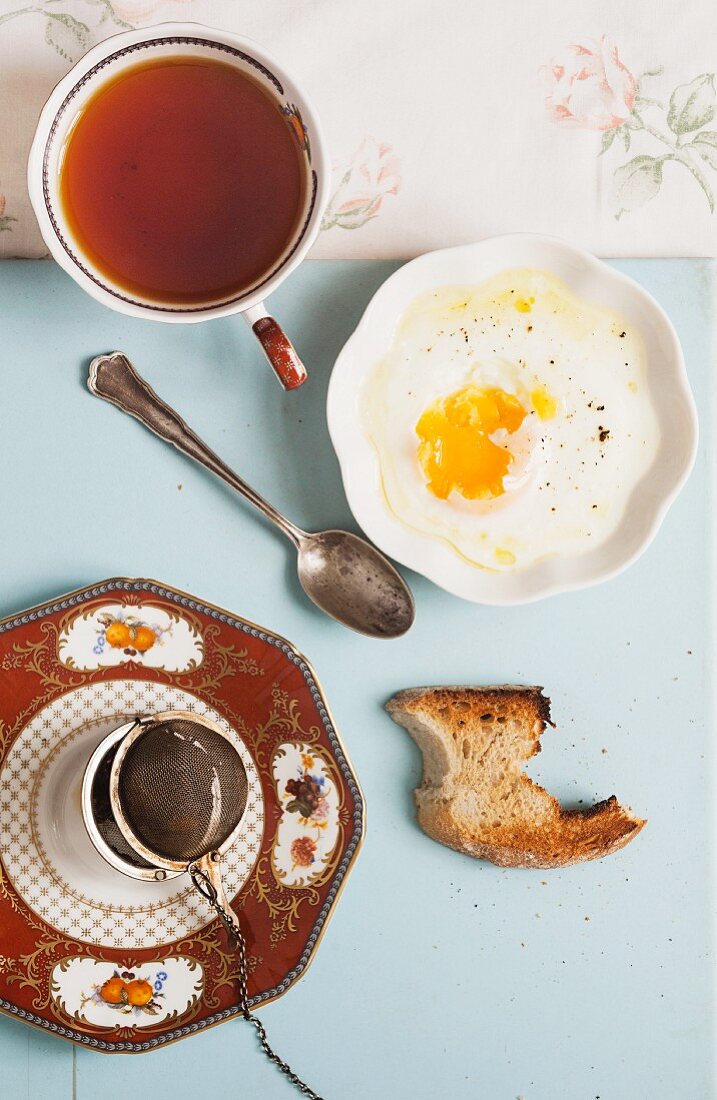 Hot tea with fried egg and toast