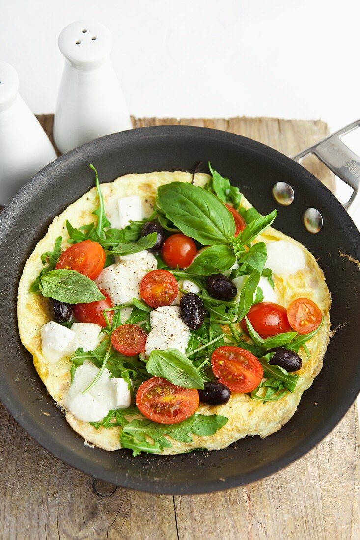 Omelette with tomatoes, olives and mozzarella