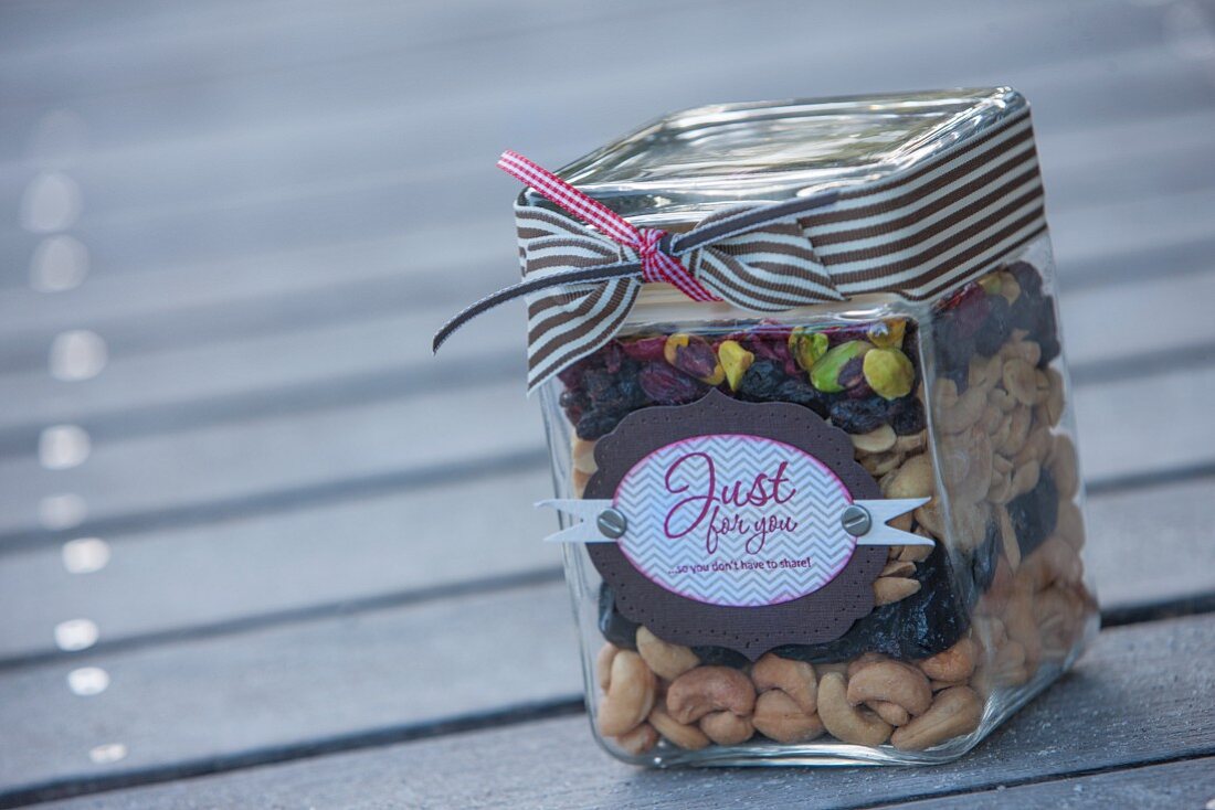 Assorted nuts and raisins layered in a jar as a gift