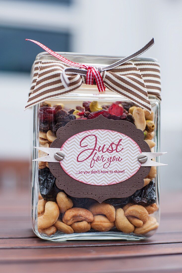 Assorted nuts and raisins layered in a jar as a gift