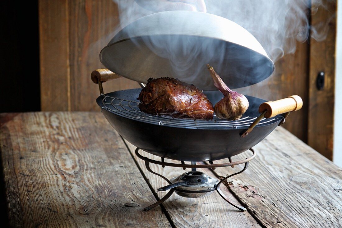 Food being smoked in a wok