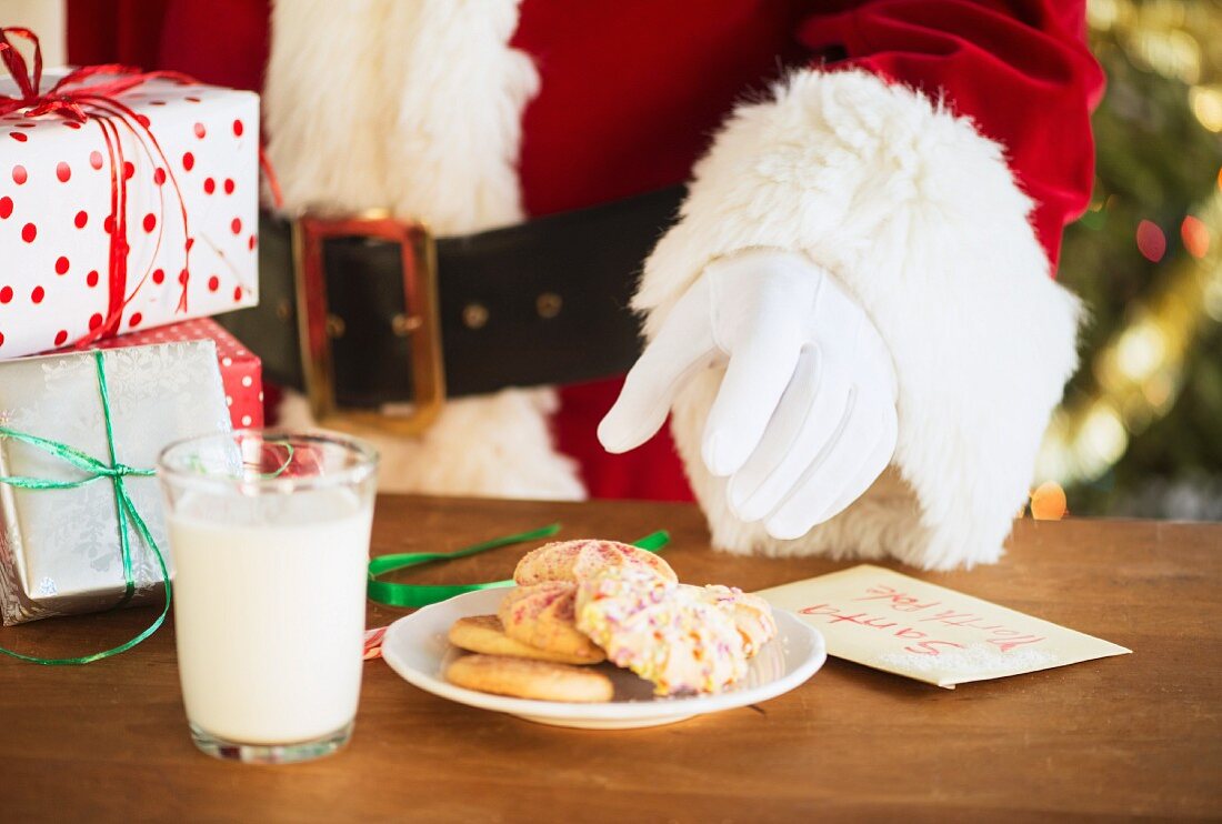 Santa claus reaching for cookie