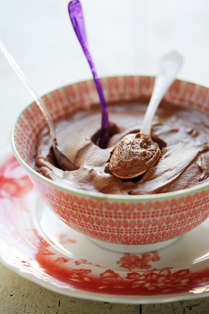 A Bowl of Chocolate Mousse with Three Spoons