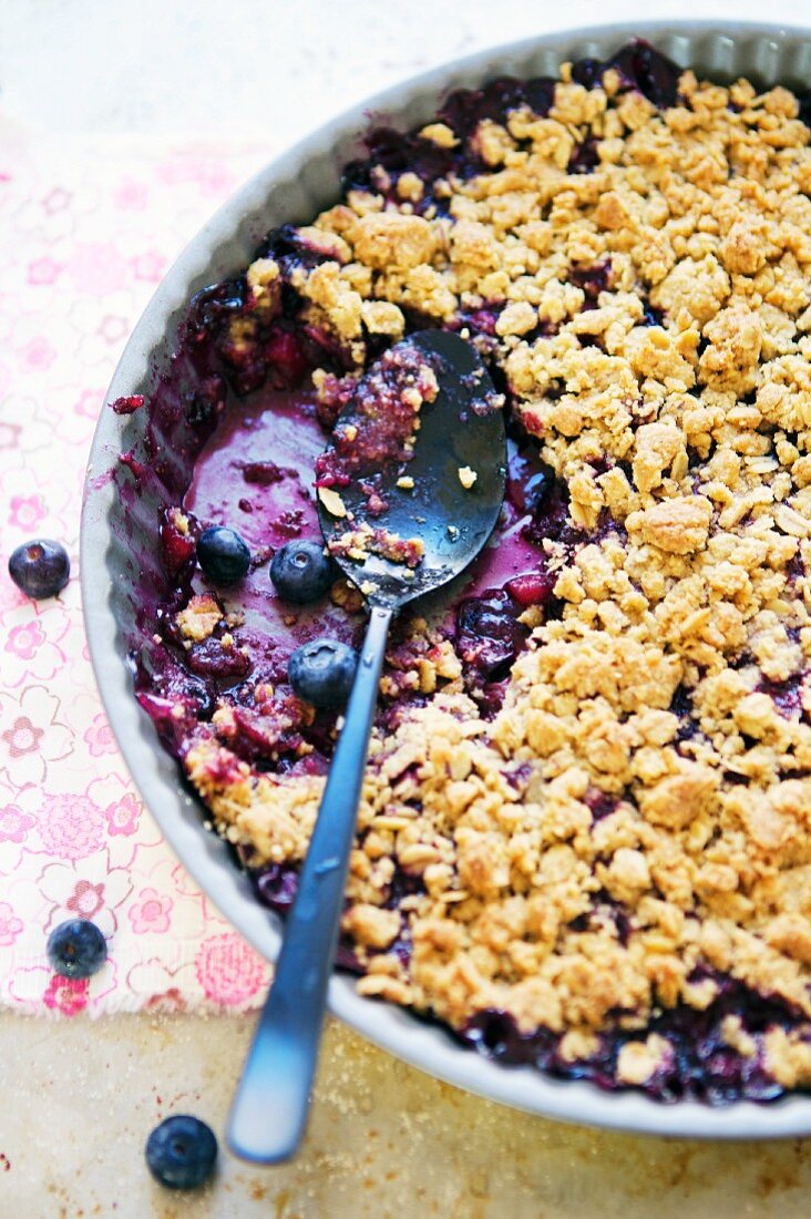 Blueberry Crumble in a Baking Dish with a Scoop Removed