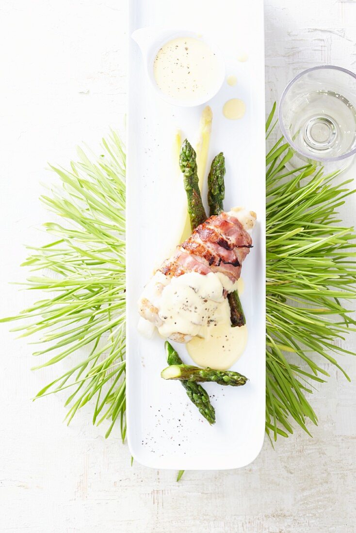 Hake wrapped in bacon with asparagus and hollandaise sauce
