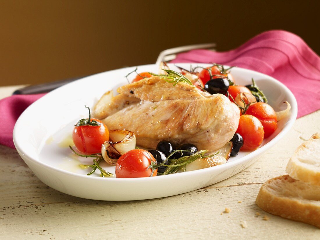 Chicken breast with tomatoes, olives, onions and rosemary