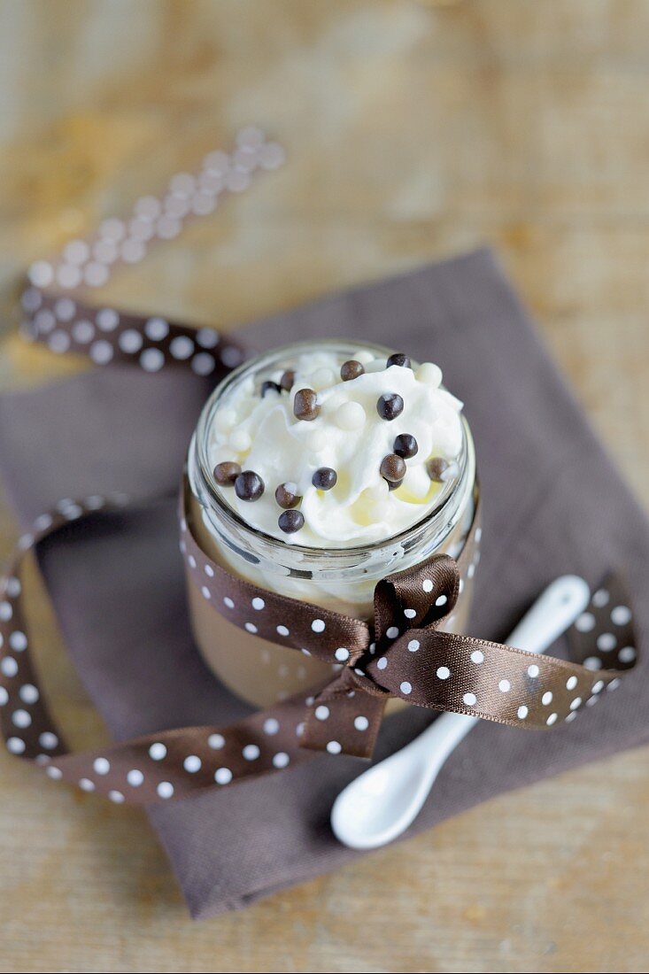 Mousse au chocolat topped with whipped cream in a screw-top jar