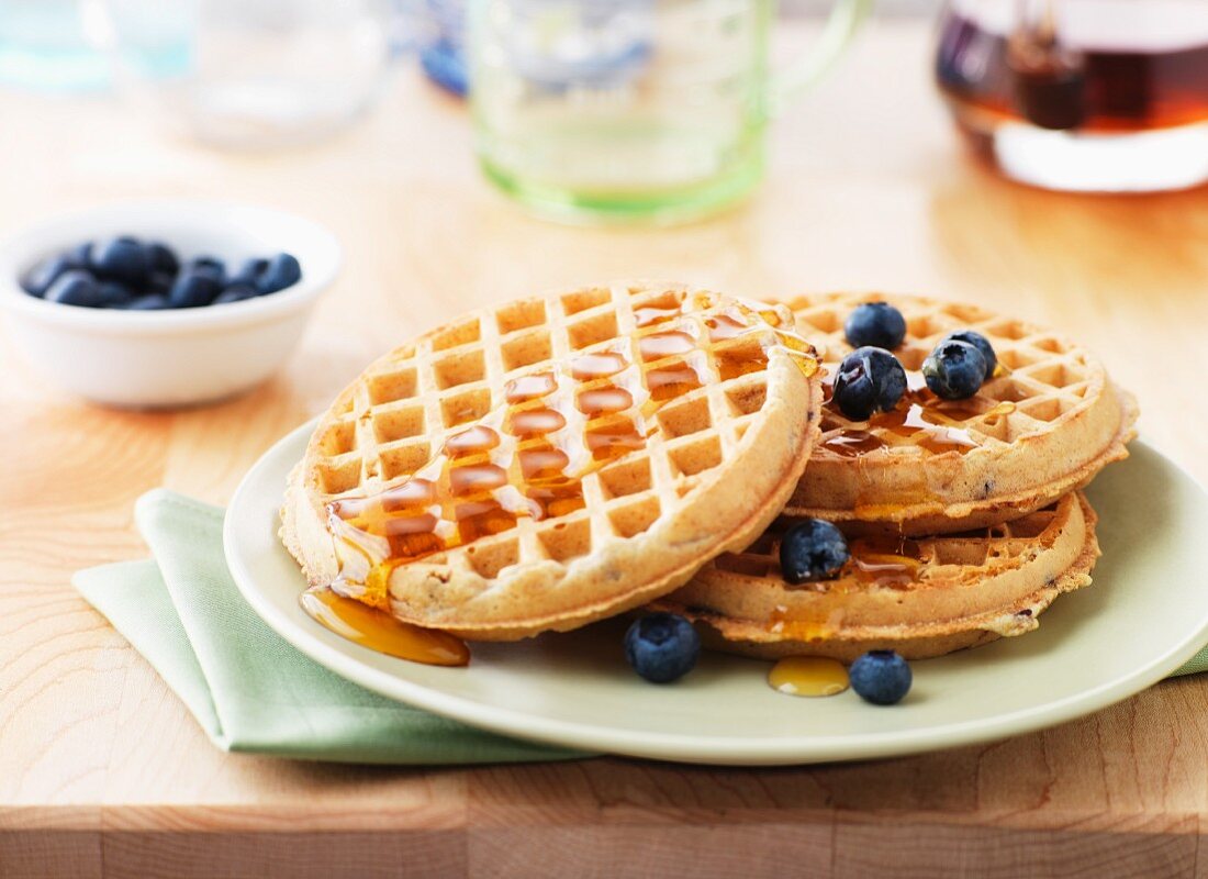 Round waffles with fresh blueberries and syrup
