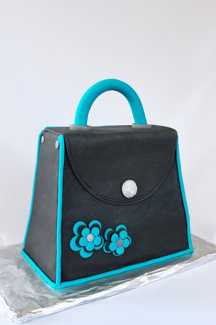 A cake decorated in fondant to look like a handbag