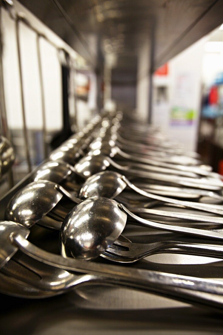 Lots of ladles in the kitchen of a restaurant