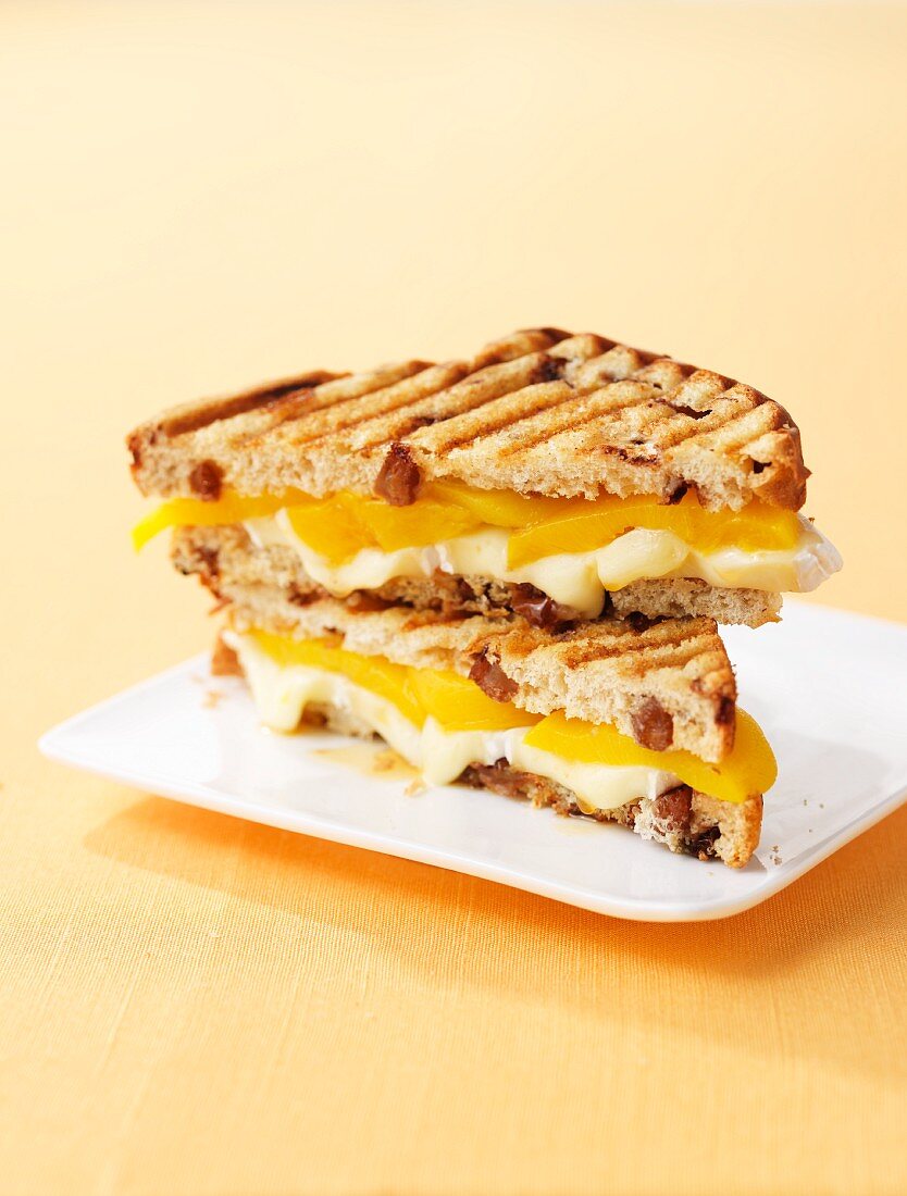 Toasted cheese sandwich with peaches and maple syrup