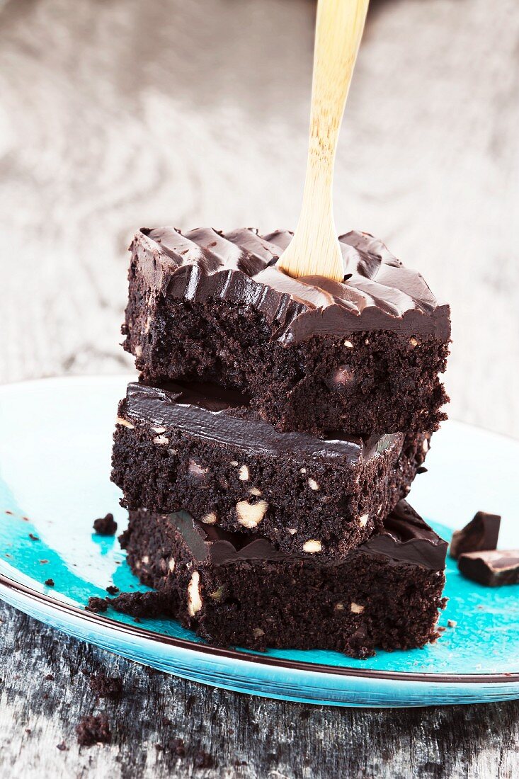 Three brownies, stacked, with a wooden fork