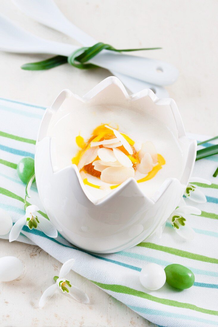 A yoghurt dessert with passion fruit sauce in an Easter porcelain bowl