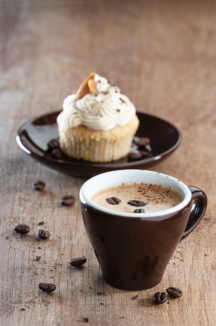 An espresso with an almond cupcake