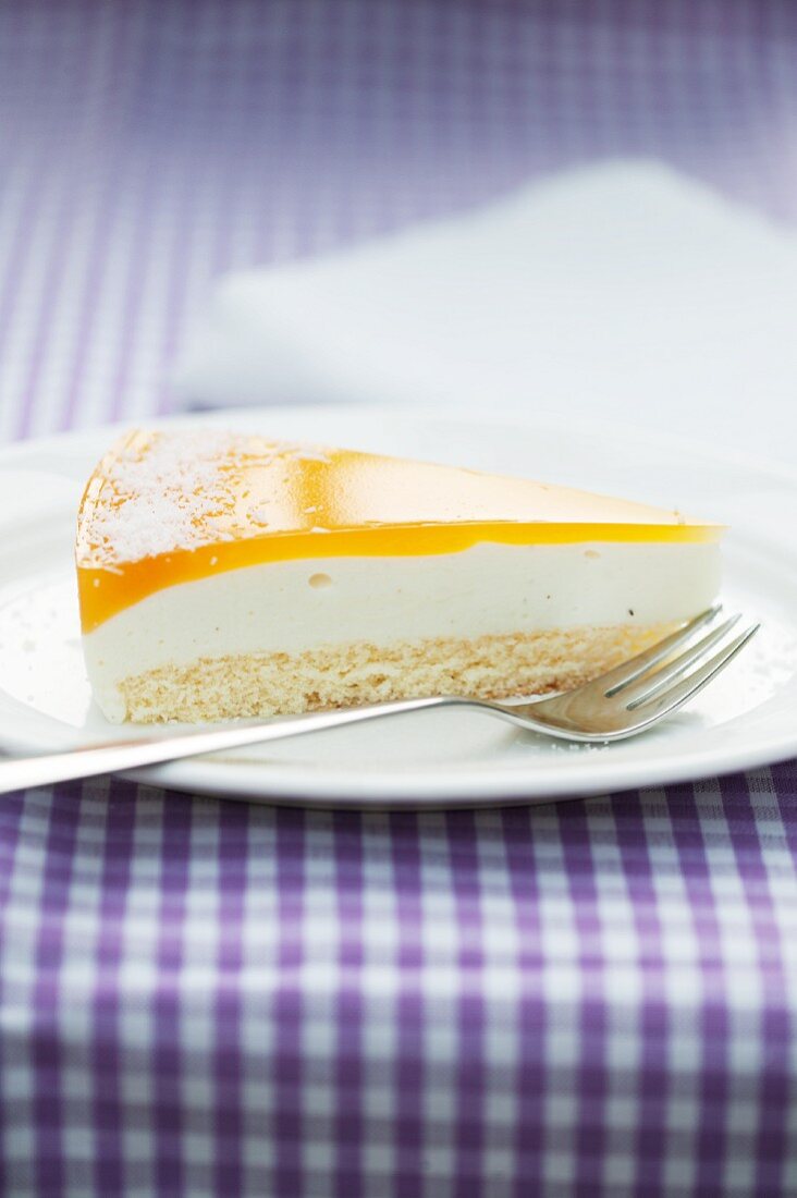 A slice of crème fraîche and vanilla cake topped with passion fruit jelly