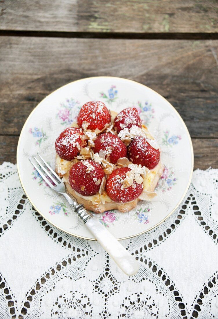 Mini sponge cake topped with custard and strawberries