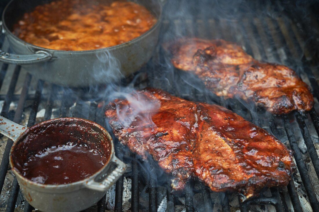 Barbecue Pork Steaks and Baked Beans on a Grill
