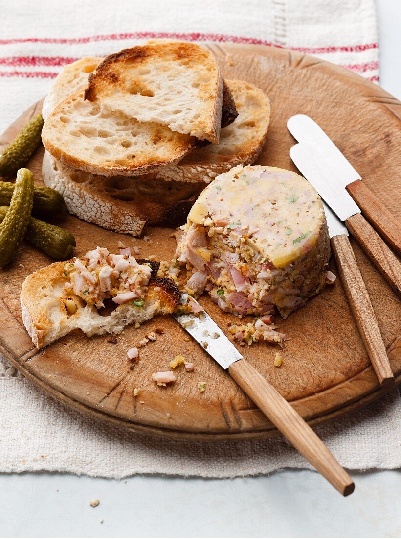 Turkey ham terrine with toasted bread and pickled gherkins