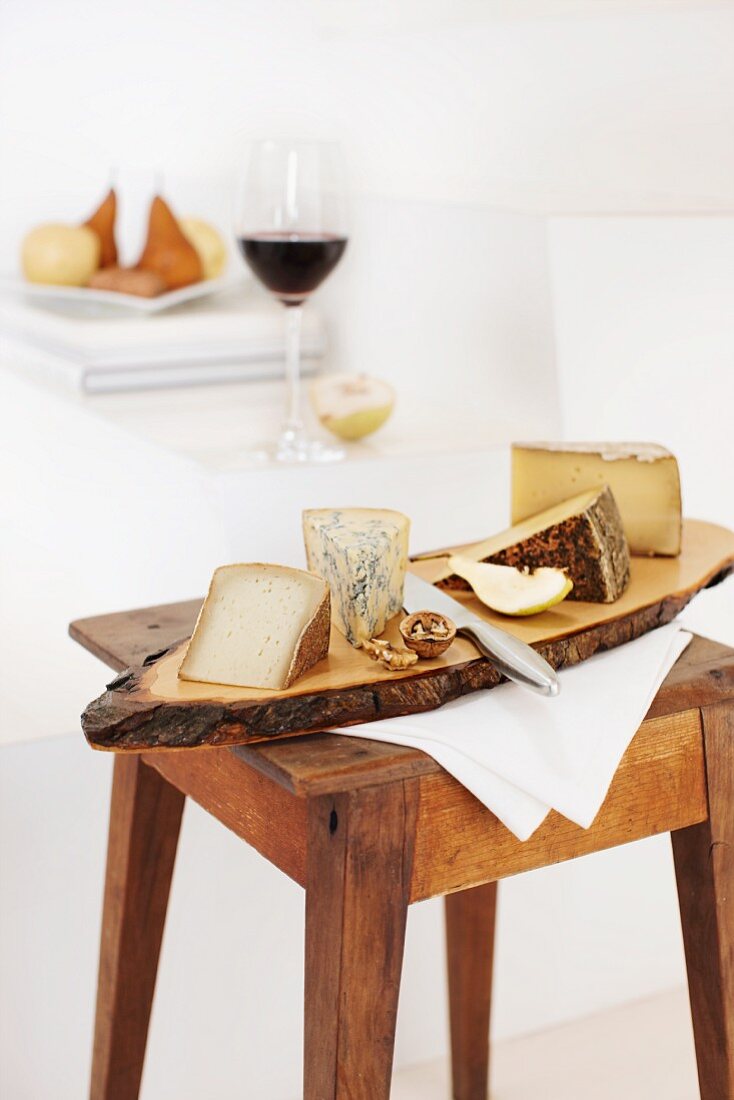 A cheeseboard with pears and walnuts