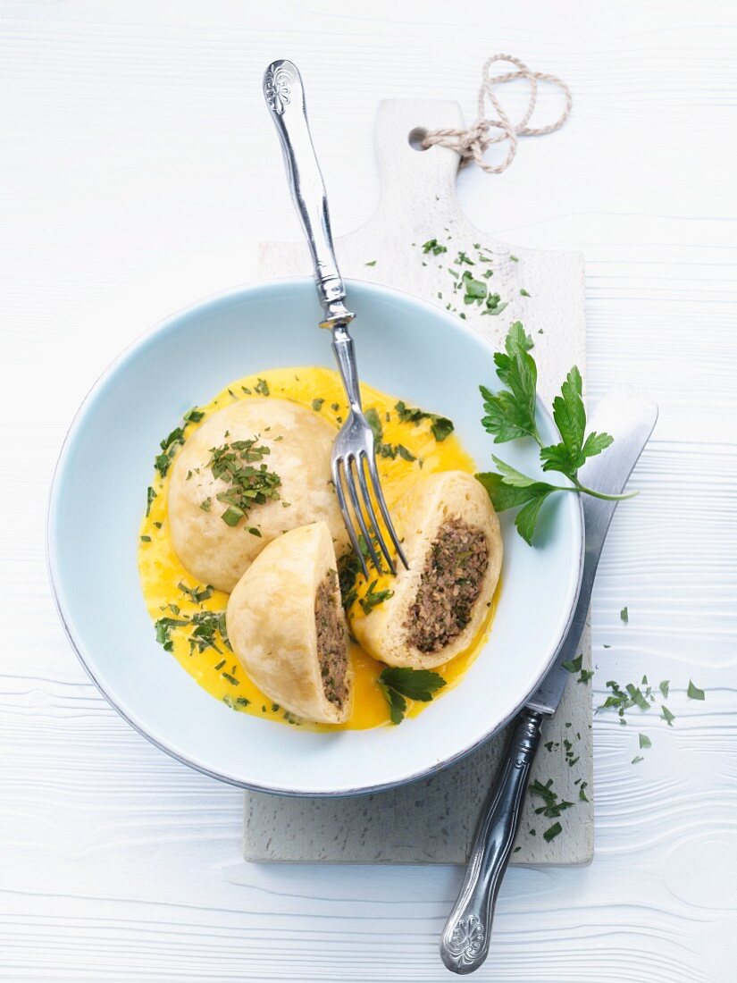 Yeast dumplings with a mushroom filling, in a squash sauce