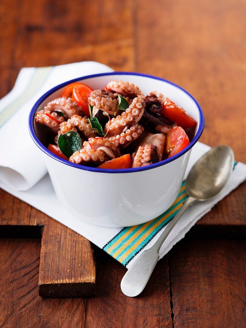 Bowl of octopus with tomatoes and chillies