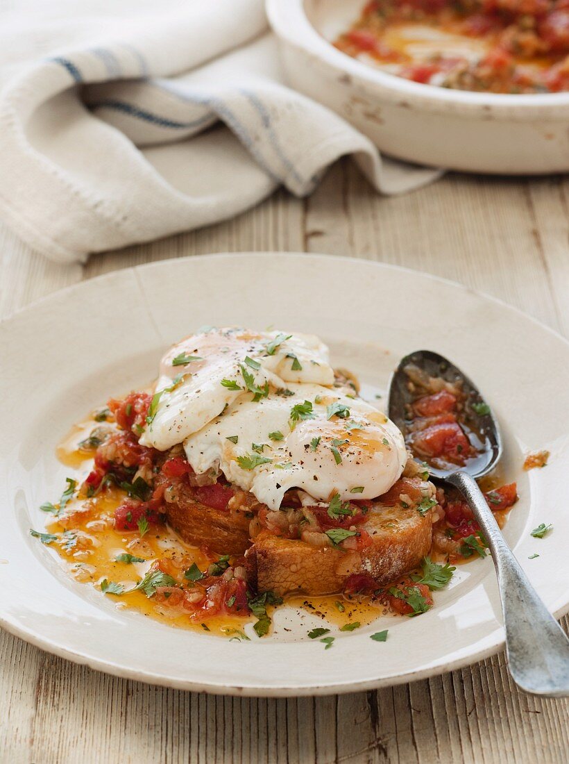 Acorda de tomate with onion sauce and poached eggs (Portugal)