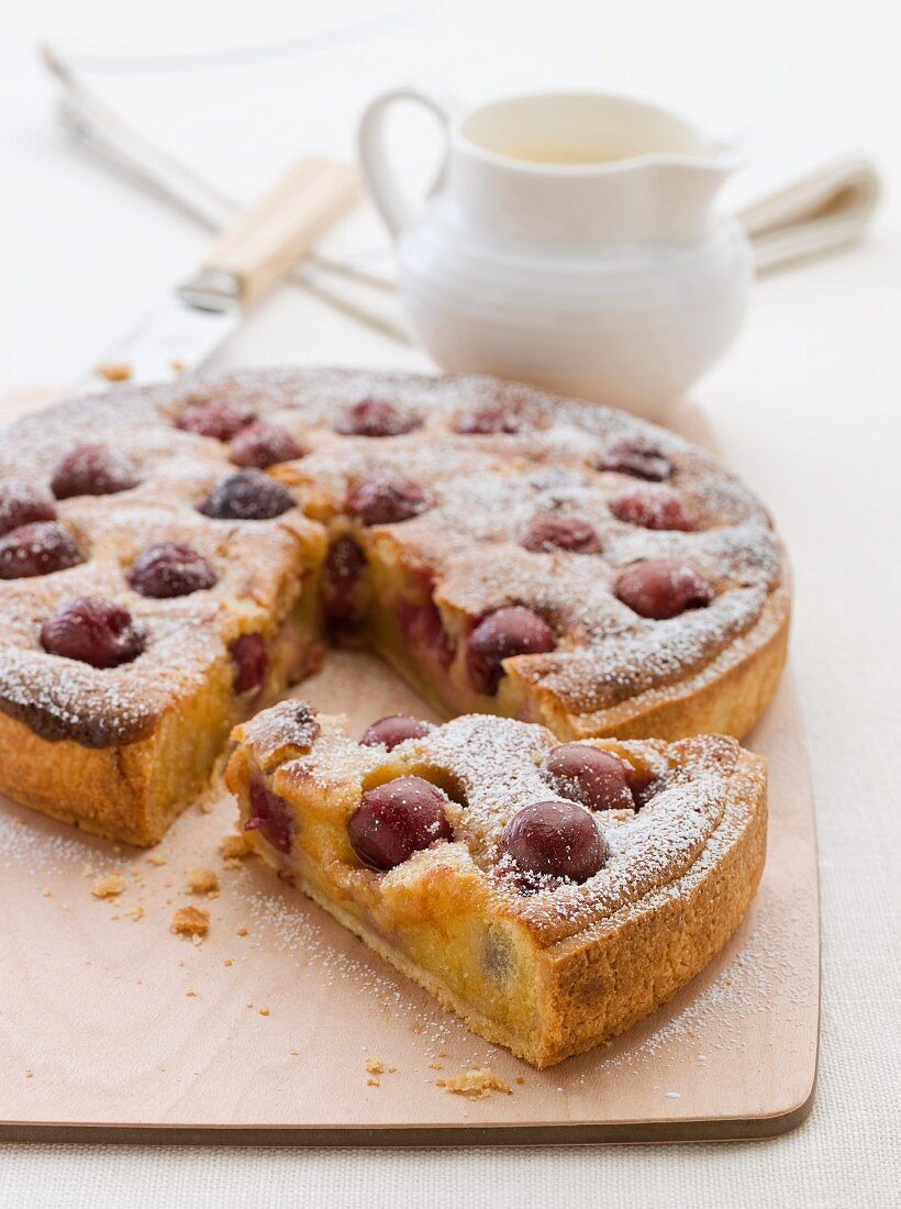 Frangipane and cherry tart with icing sugar