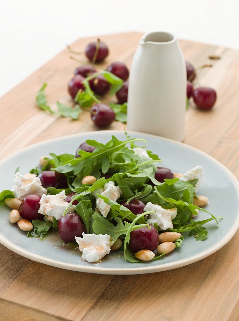 Rocket salad with cherries, feta and almonds